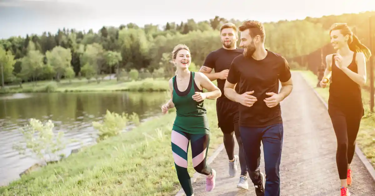 Group of people jogging together outdoors, representing community, diversity, and supportive social relationship