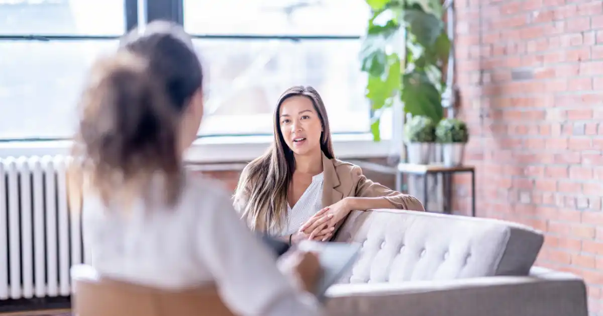 Psychologist and client in a therapy session, illustrating relational and trauma-informed psychological support