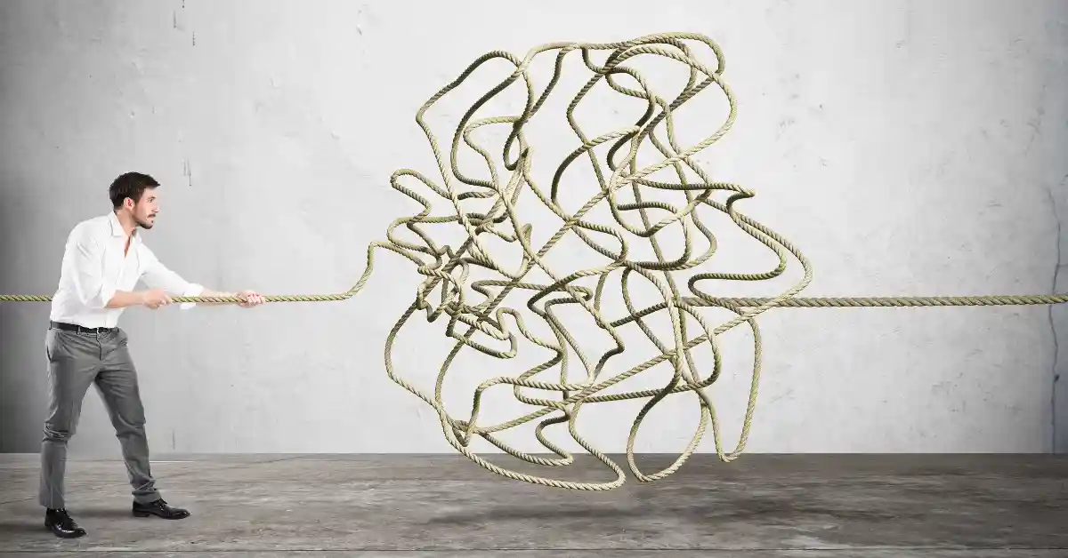 Person pulling on a tangled rope, representing the challenge and complexity of living with persistent pain