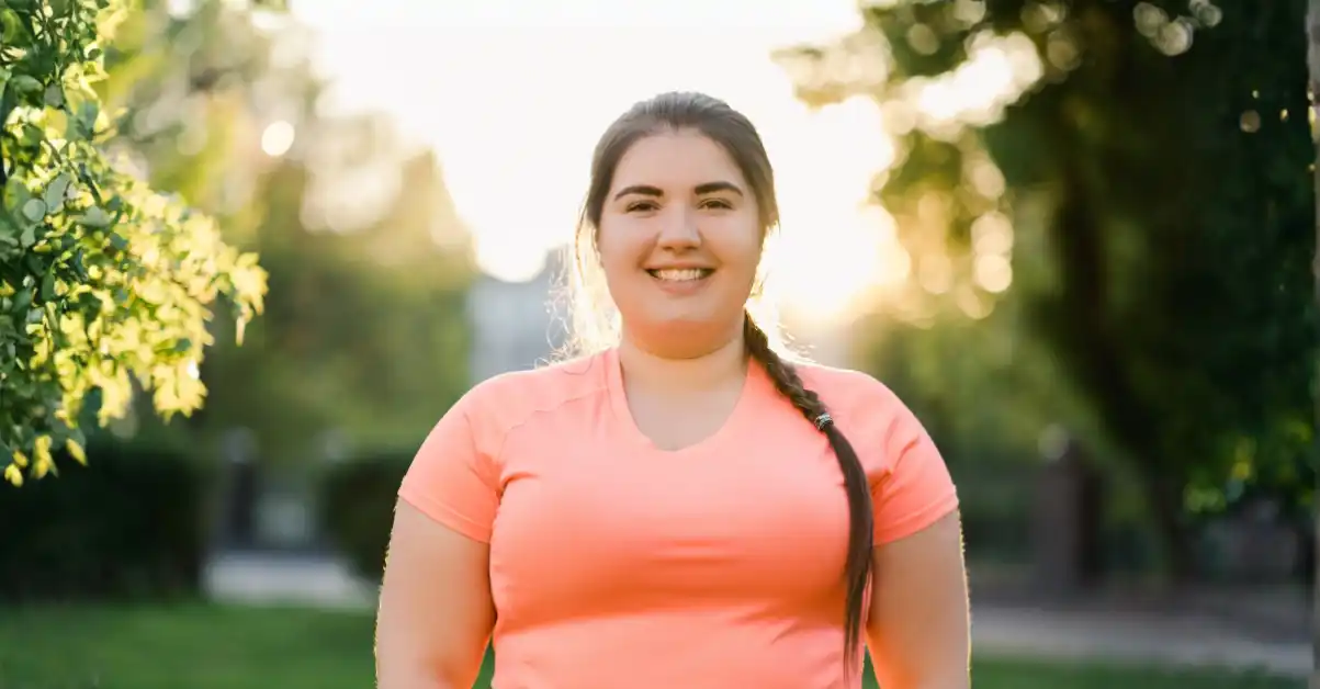 cultural-social-roots-body-image A woman standing outdoors representing cultural influences on body image and social perceptions