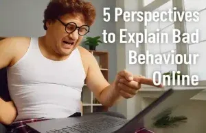 A person wearing glasses points at a computer screen, symbolizing online interaction and the concept of digital disrespect.